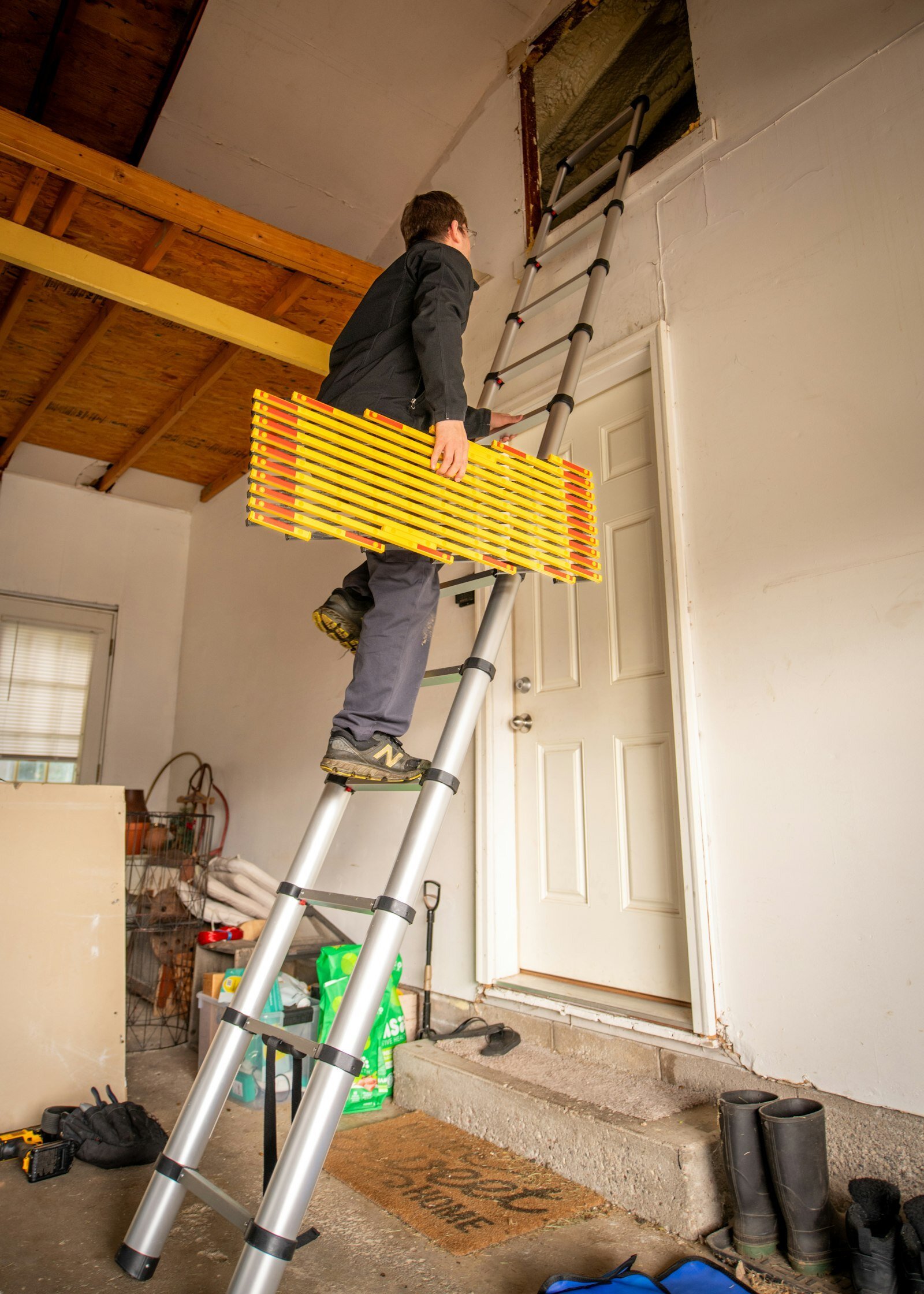 Technician installing attic insulation in Phoenix home